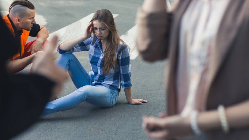 conscious casualty accident sitting on road